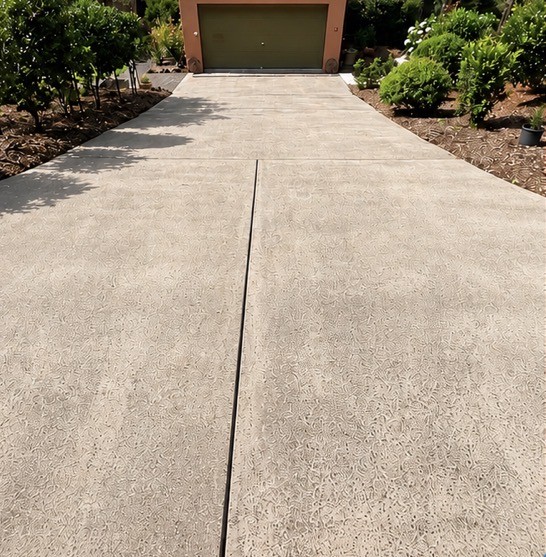Same concrete driveway restored to near-new after high pressure cleaning