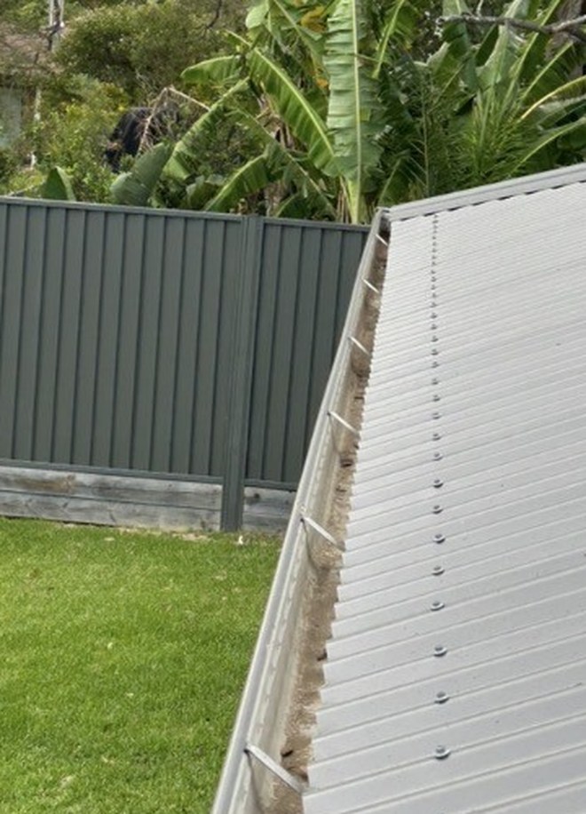 Same gutter fully cleared and flowing freely after Barnzy gutter clean